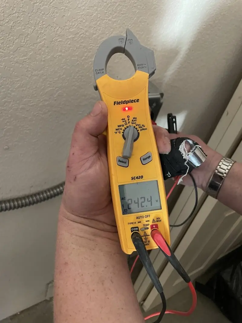 Voltage testing with clamp meter during Outlet Installation in Baxter Springs